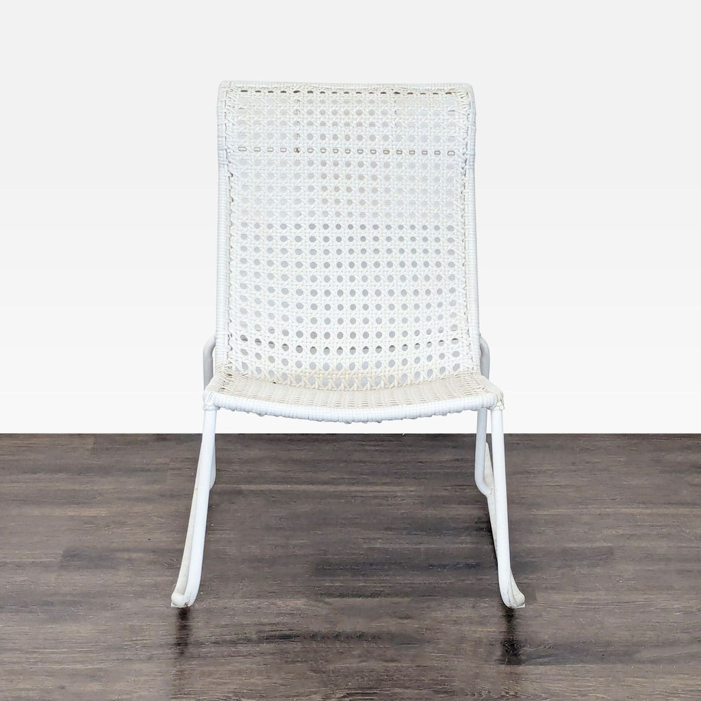 White modern rocking chair with woven plastic wicker seat and metal frame, suitable for indoor relaxation.