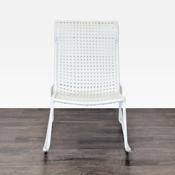 White modern rocking chair with woven plastic wicker seat and metal frame, suitable for indoor relaxation.