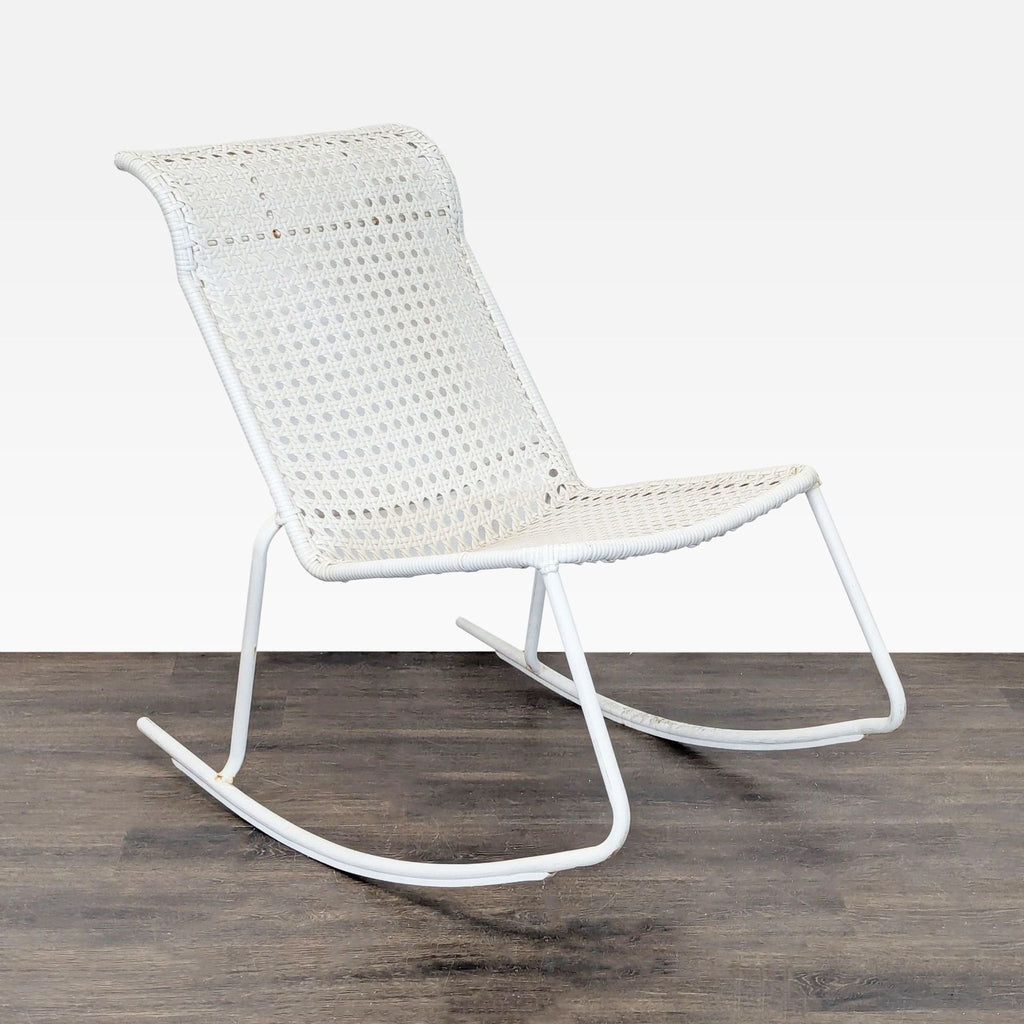 Lightweight white chair with metal base and woven back, designed for gentle rocking in any room or porch.