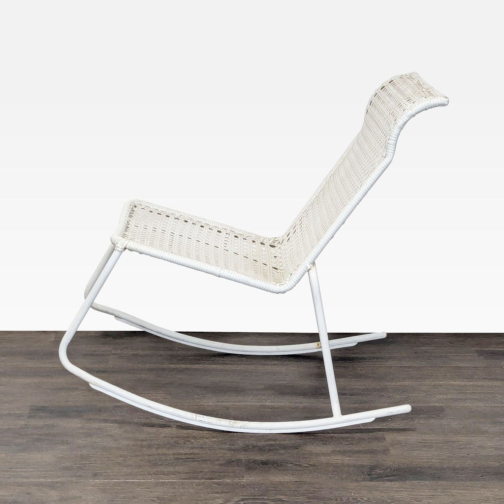 Contemporary white rocking chair; metal frame and plastic wicker offer sturdy, comfortable seating for any space.