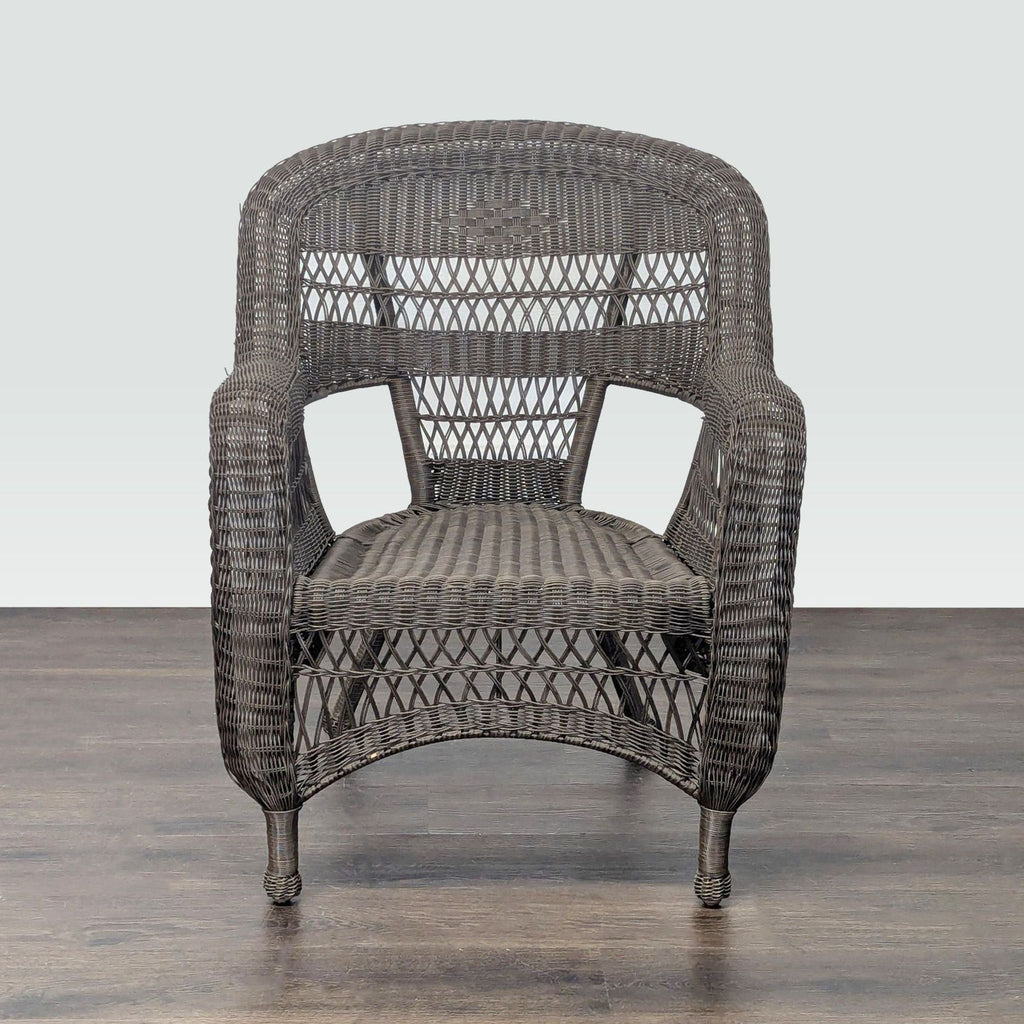Brown wicker armchair with woven all-weather material, suitable for both indoor and outdoor seating areas.  