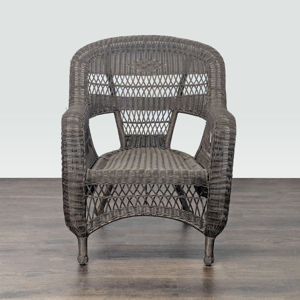 Brown wicker armchair with woven all-weather material, suitable for both indoor and outdoor seating areas.  