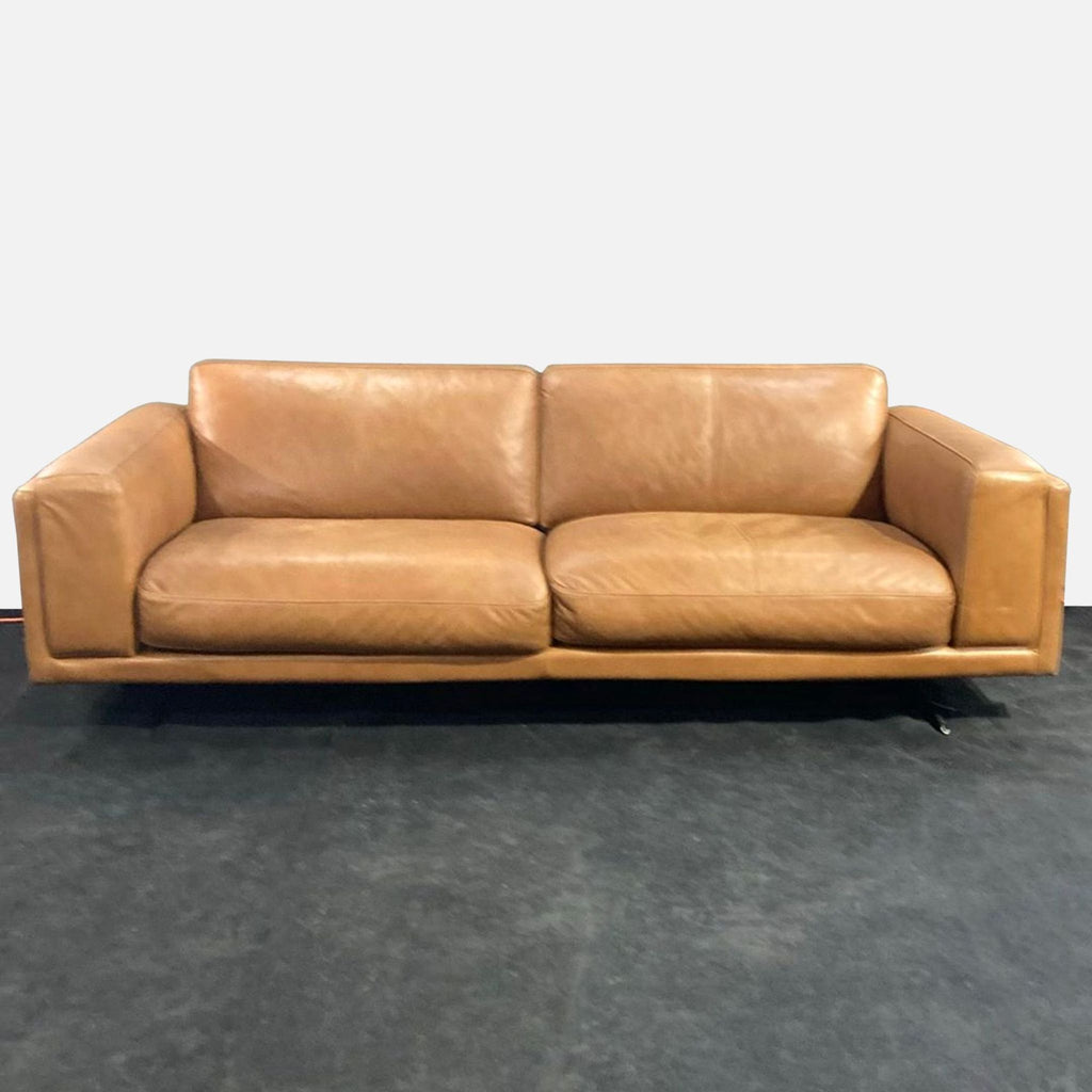 1. Copenhagen Furniture 3-seat sofa in tan leather, shown with wide armrests and plush cushions on a dark floor.