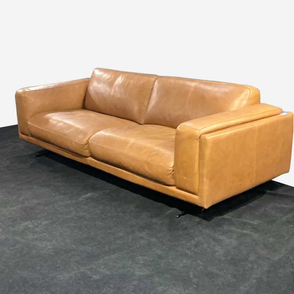2. Angled view of a tan leather 3-seat Copenhagen Furniture sofa, highlighting its modern boxy shape and comfort.