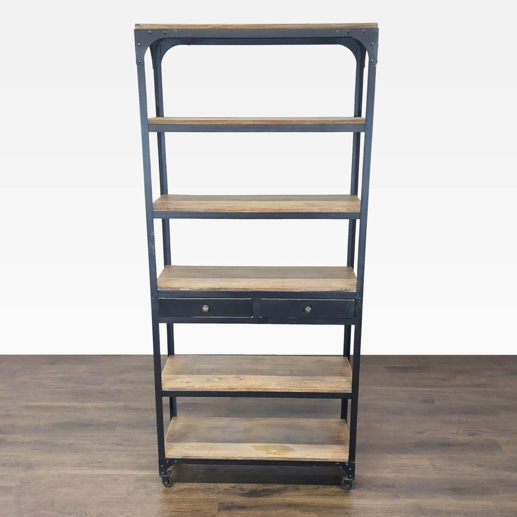 Anthropologie bookshelf with five wood shelves, two drawers, and lockable wheels in a modern industrial style.  