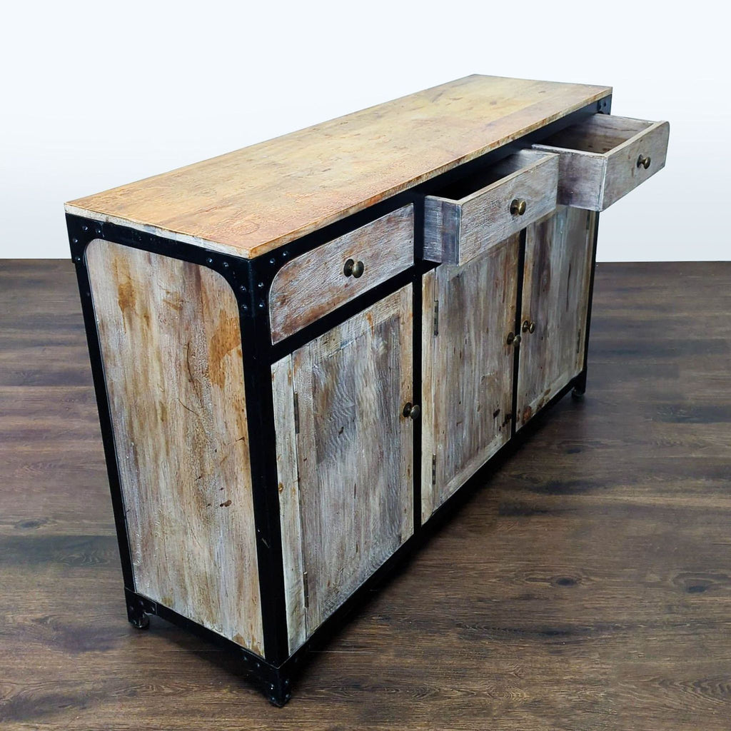 Anthropologie credenza featuring three drawers, three doors, and shelving, shown in a weathered style.