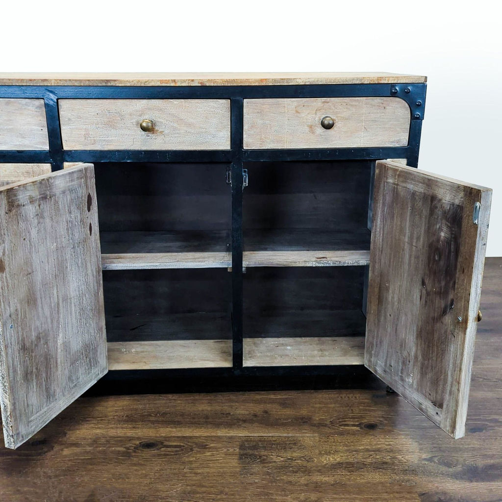 Three-door, three-drawer cabinet in a rustic finish, part of Anthropologie’s Sideboard & Credenza collection.