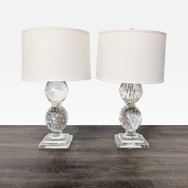 Pair of Pottery Barn crystal table lamps with white shades and square bases, ideal for versatile lighting decor.  