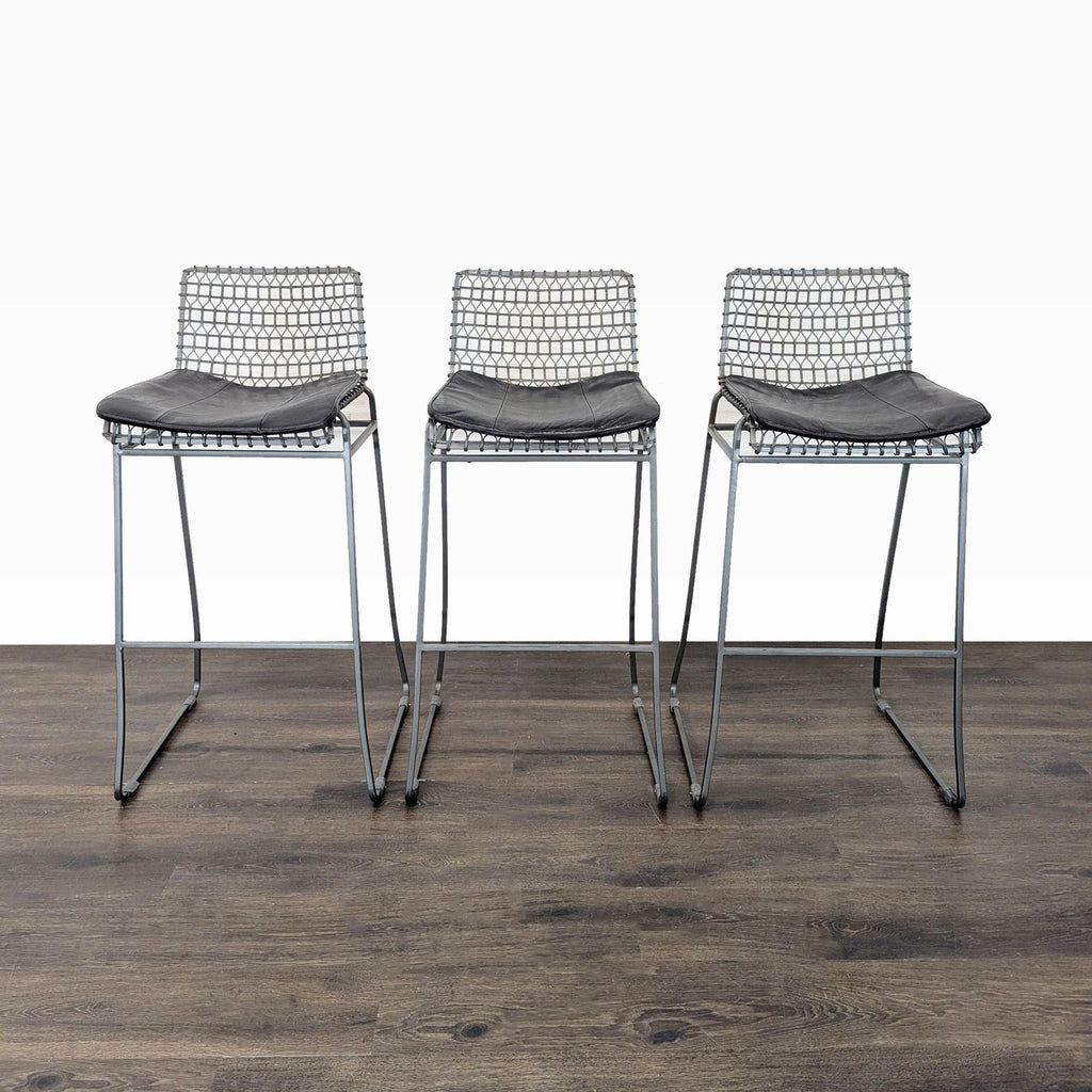 1. Set of three Crate & Barrel handcrafted wire bar stools with cushioned seats and welded iron patina finish.