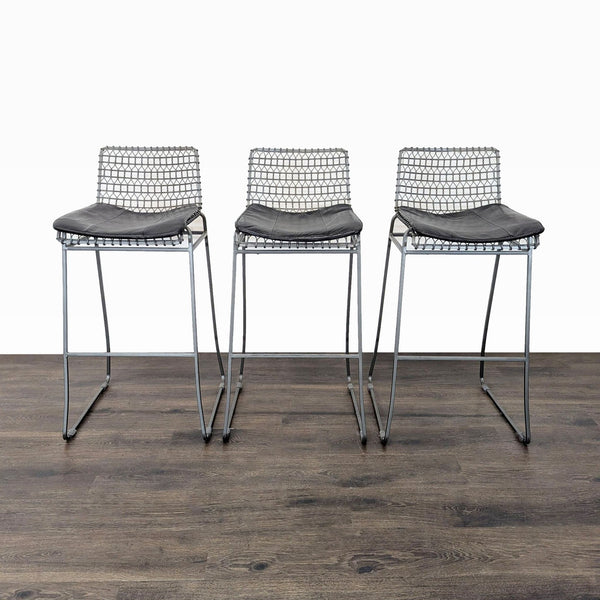 1. Set of three Crate & Barrel handcrafted wire bar stools with cushioned seats and welded iron patina finish.
