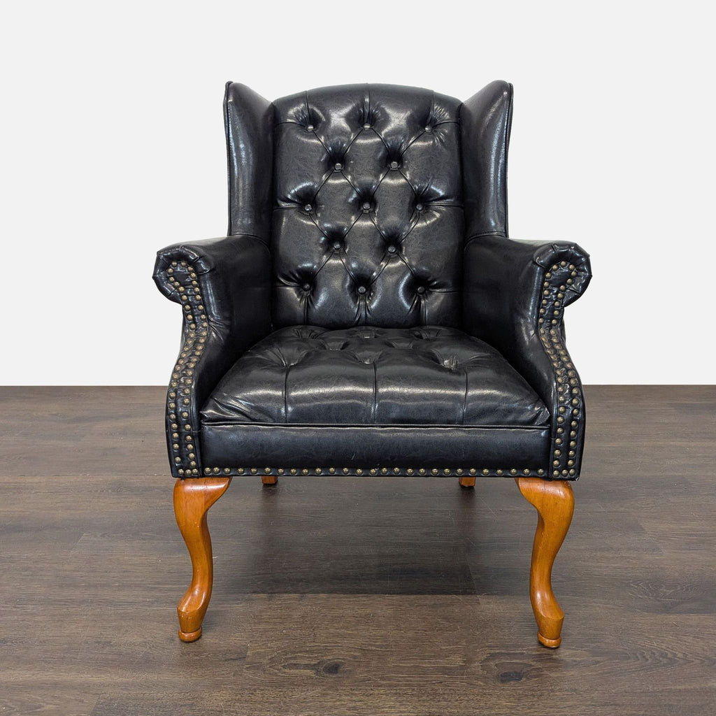 Classic Coaster lounge chair in black leather with tufted backrest and wood legs, paired with a matching ottoman.