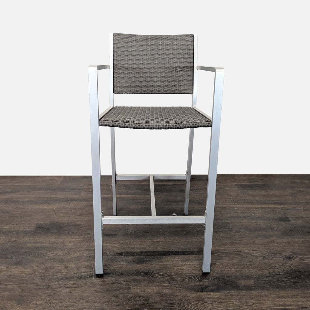 Neutral-tone bar stools from Christopher Knight Home featuring woven wicker seats, sturdy metal legs, and comfortable armrests.