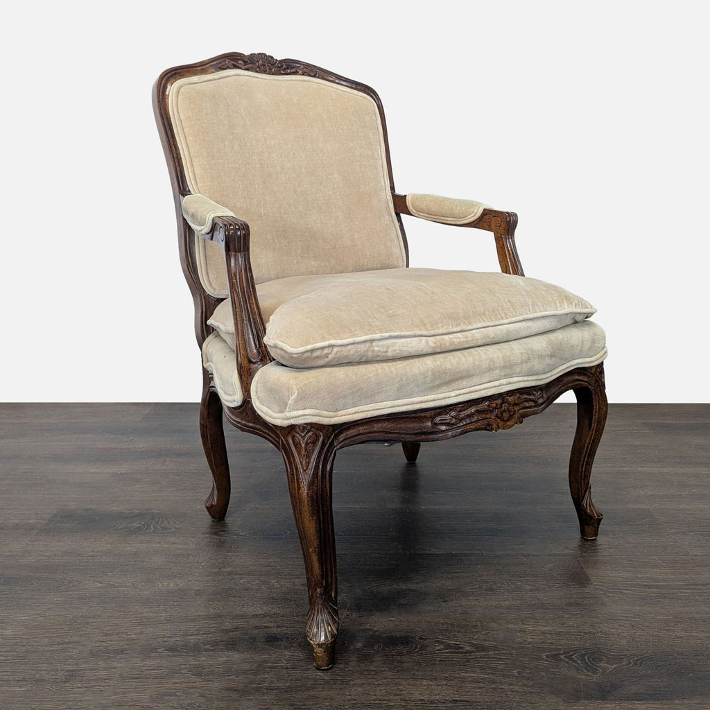 2. Angled side view of a classic lounge chair featuring beige fabric, cushioned seat, and carved wooden arms.