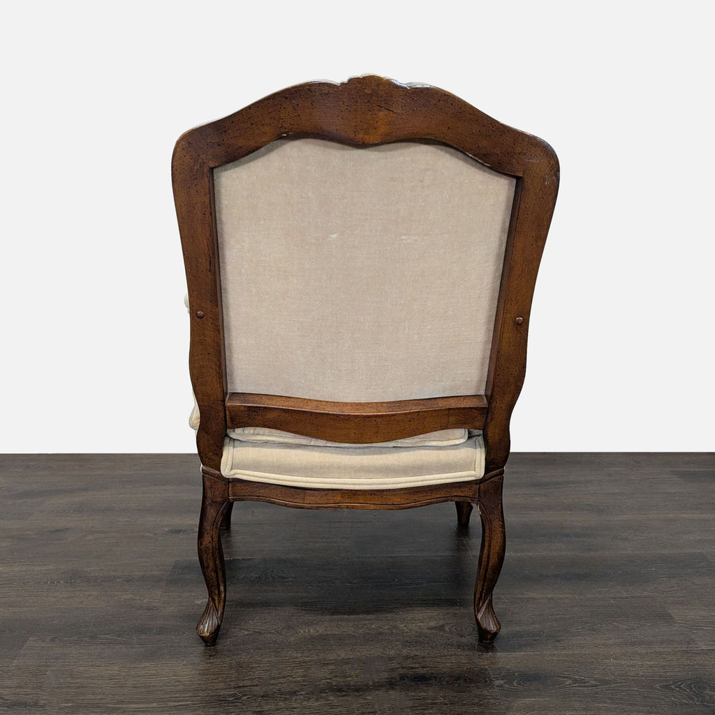 3. Rear view of a lounge chair showing beige upholstery, curved wooden frame, and elegant cabriole legs.