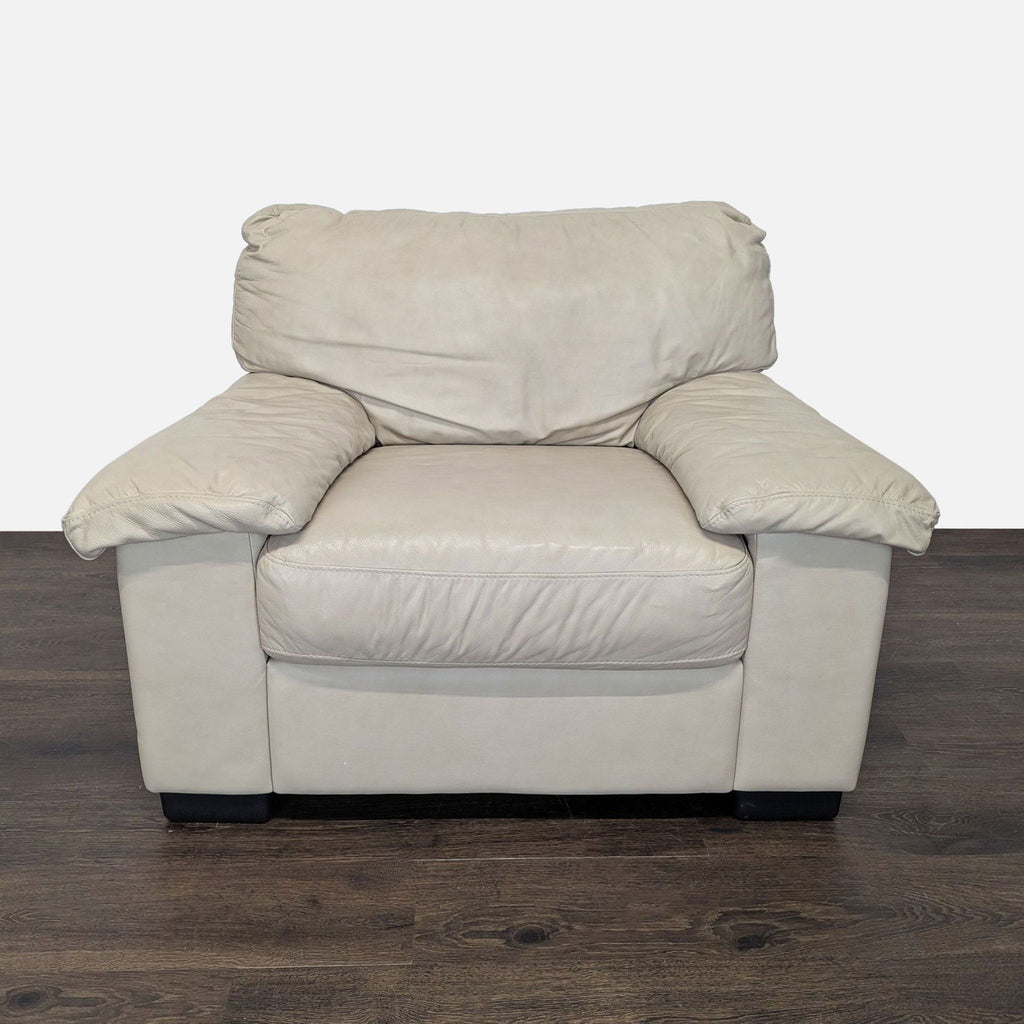 1. Front view of a plush beige leather Italsofa lounge armchair with cushioned seat and wide armrests.