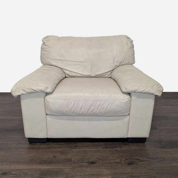 1. Front view of a plush beige leather Italsofa lounge armchair with cushioned seat and wide armrests.