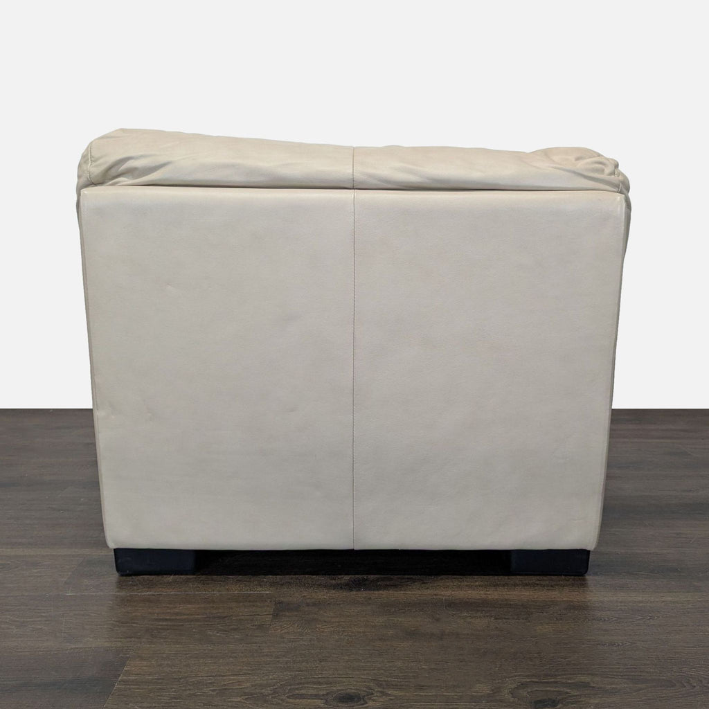 3. Rear view of a beige leather Italsofa lounge armchair, highlighting clean lines and padded backrest.