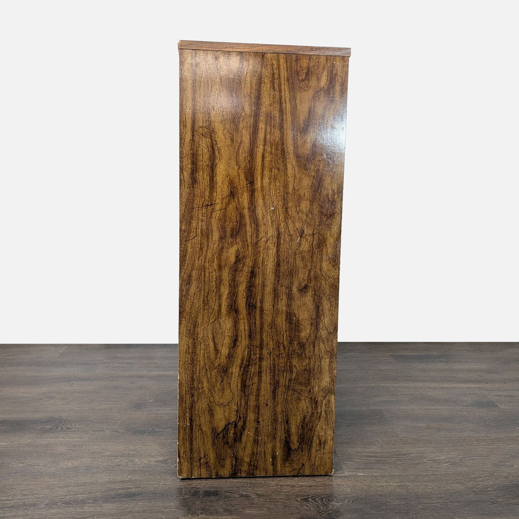Side view of a sturdy wooden dresser with a brown wood finish, highlighting its smooth, grainy texture.