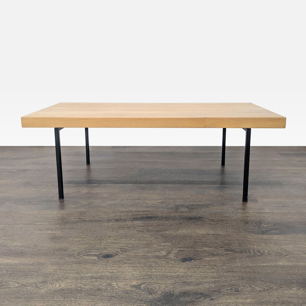 1. Modern EQ3 coffee table with wood top and black metal legs, ideal for minimalist living or office spaces.  