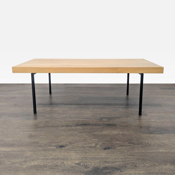 1. Modern EQ3 coffee table with wood top and black metal legs, ideal for minimalist living or office spaces.  