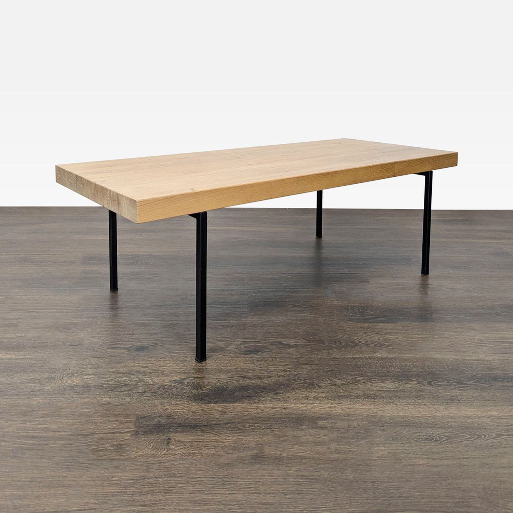 3. Minimalist EQ3 coffee table with a light wood top and sleek black legs, easy to match with any décor.