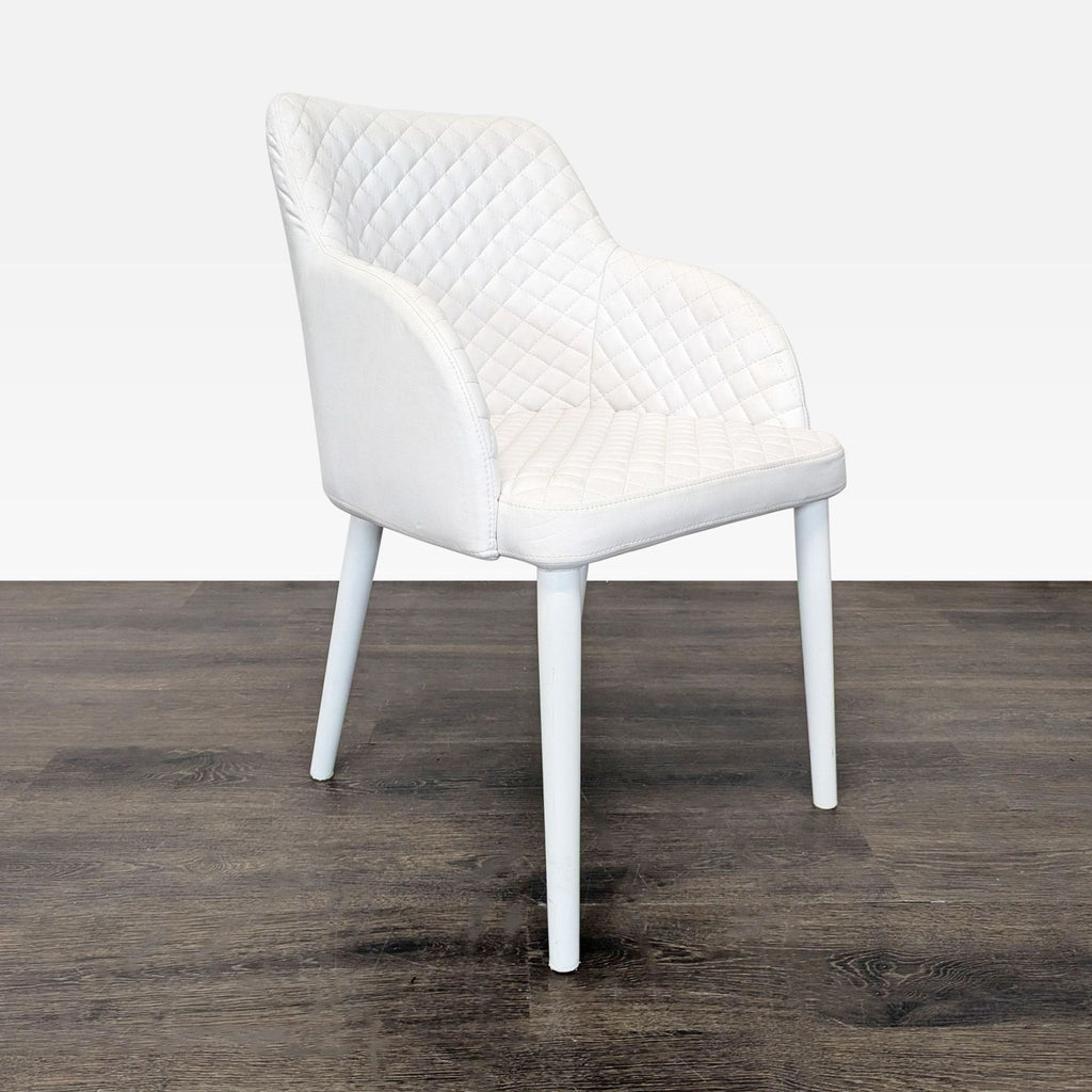 2. Side profile of a single Moe's Home Collection dining chair with quilted upholstery and white legs.