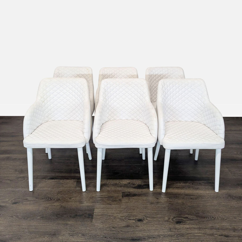 1. Set of six white diamond-stitched Moe's Home Collection dining chairs arranged on a dark wood floor.