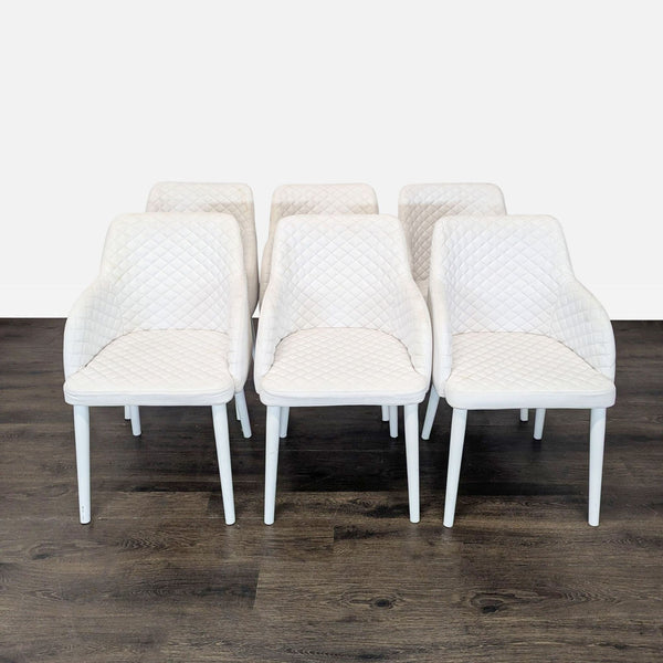 1. Set of six white diamond-stitched Moe's Home Collection dining chairs arranged on a dark wood floor.