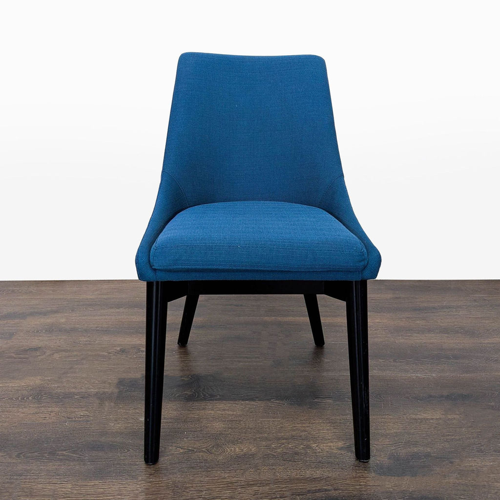 1. Front view of a Modway dining chair with blue upholstery and black wooden legs on a wooden floor.