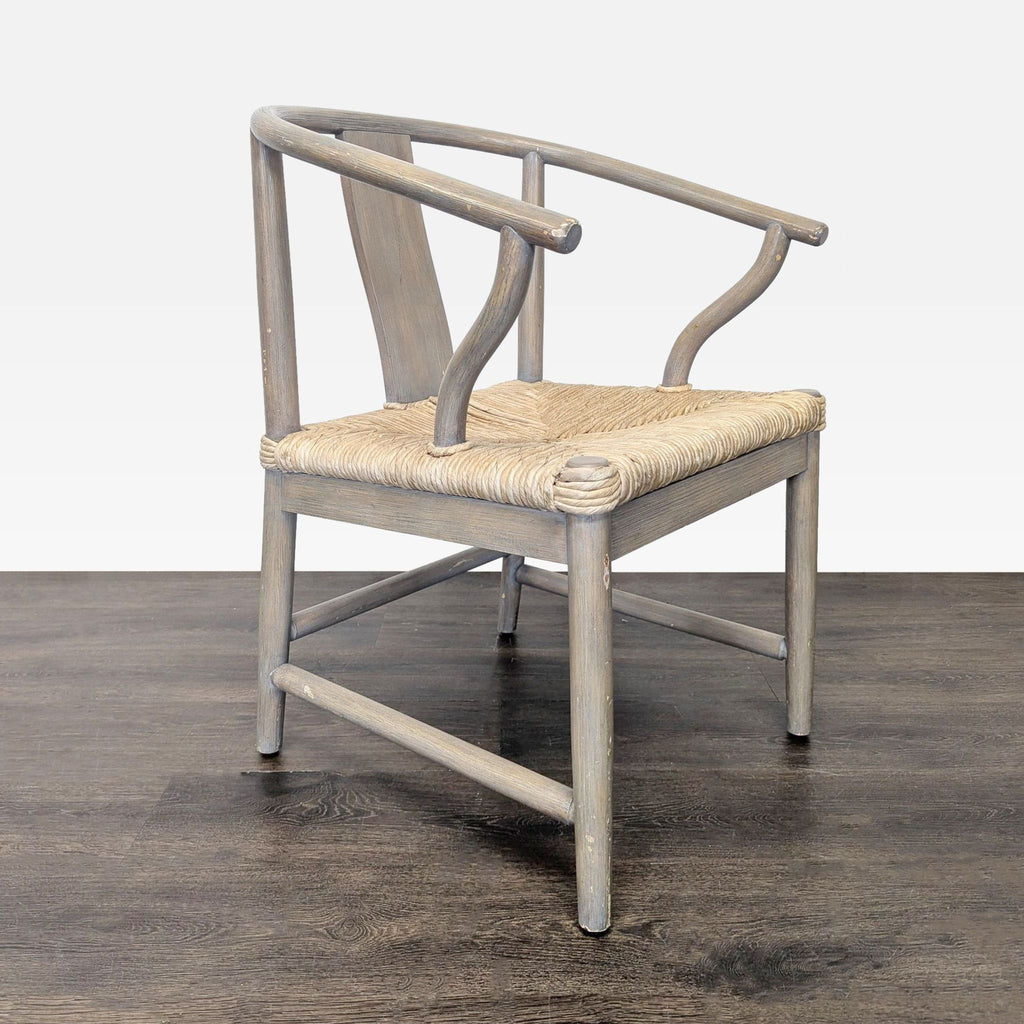 2. Side angle of an iconic Wishbone-inspired dining chair, showing the sculpted armrests and woven seat.  