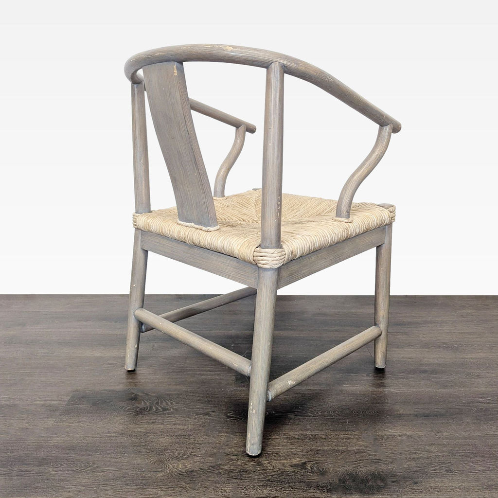3. Rear perspective of a Hans Wegner-style dining chair, highlighting the curved backrest and elegant wooden frame.