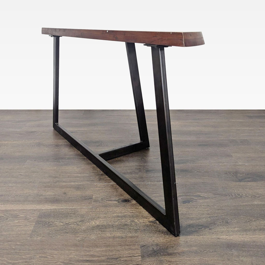 Moe’s side console table featuring a wood surface and blackened steel legs.