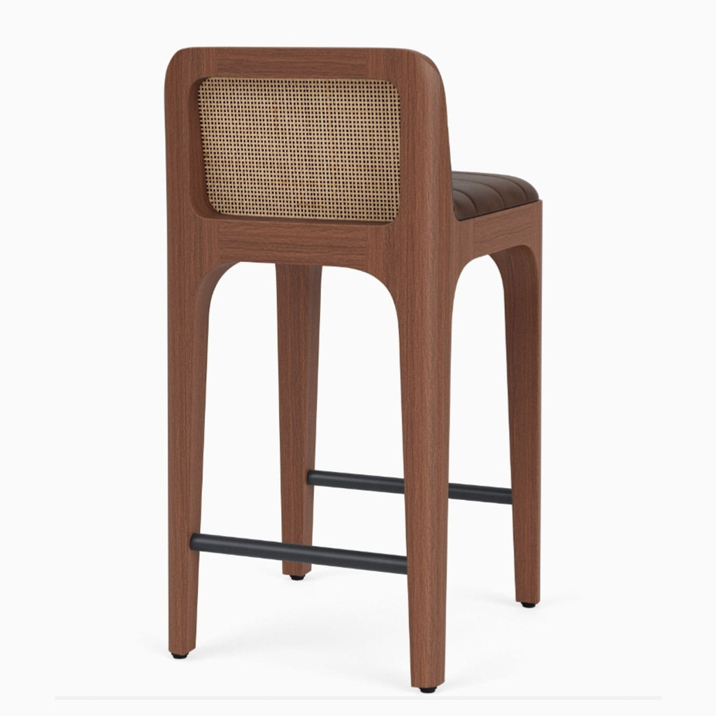 Modern chair by Denver Modern featuring a walnut maple frame, tufted leather upholstery, and cane backing.