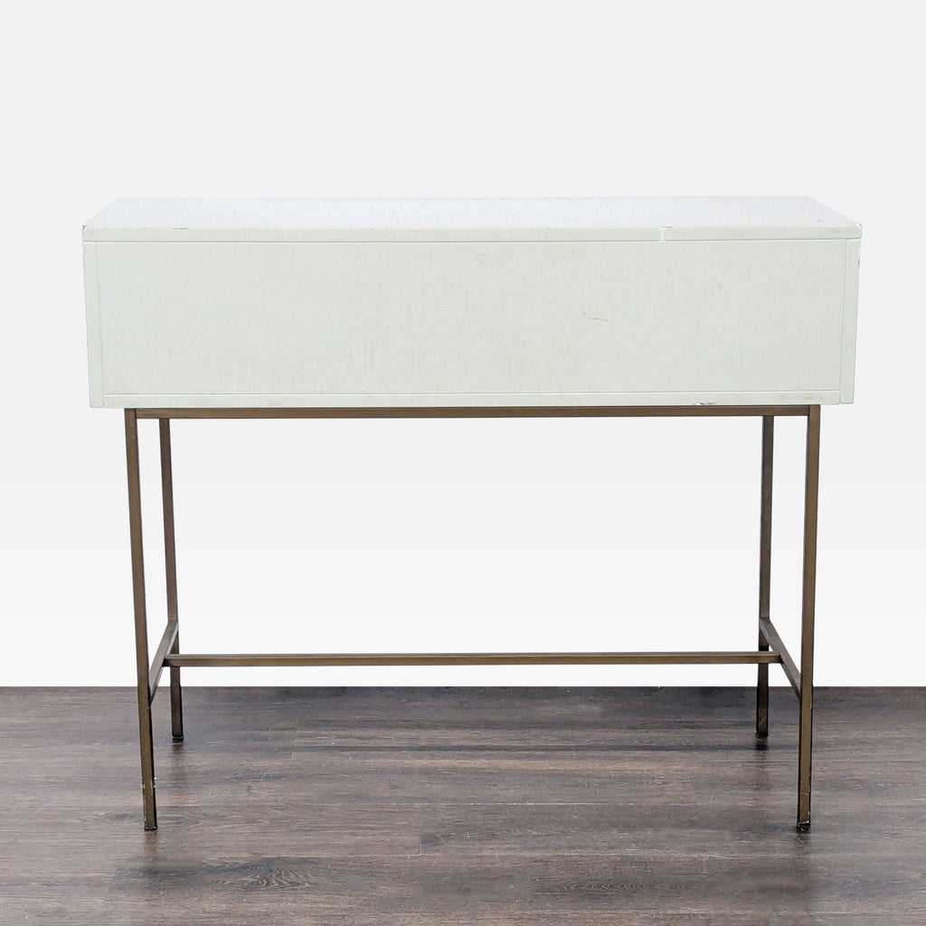 Sleek West Elm side table with powder-coated parchment drawers above antique brass-finished legs.