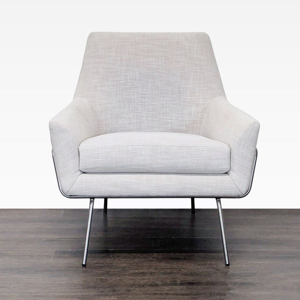 West Elm lounge chair with mid-century lines, oatmeal upholstery, and chrome legs, perfect for modern interiors.
