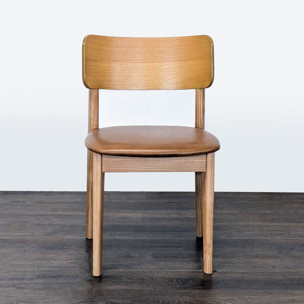 West Elm dining chair with top grain leather cushion, ash wood frame, and acacia veneer backrest.
