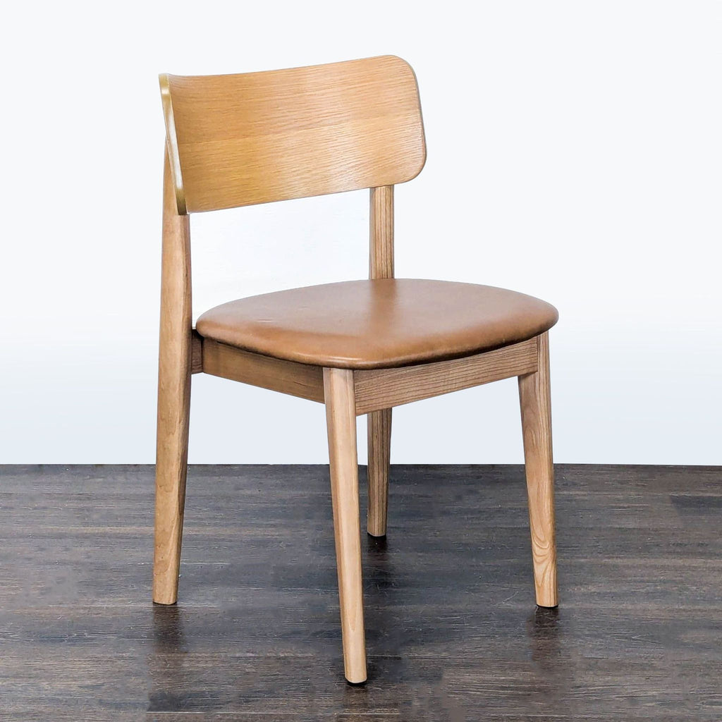 Modern dining chair featuring leather seat, solid ash legs, and a curved acacia veneer backrest by West Elm.