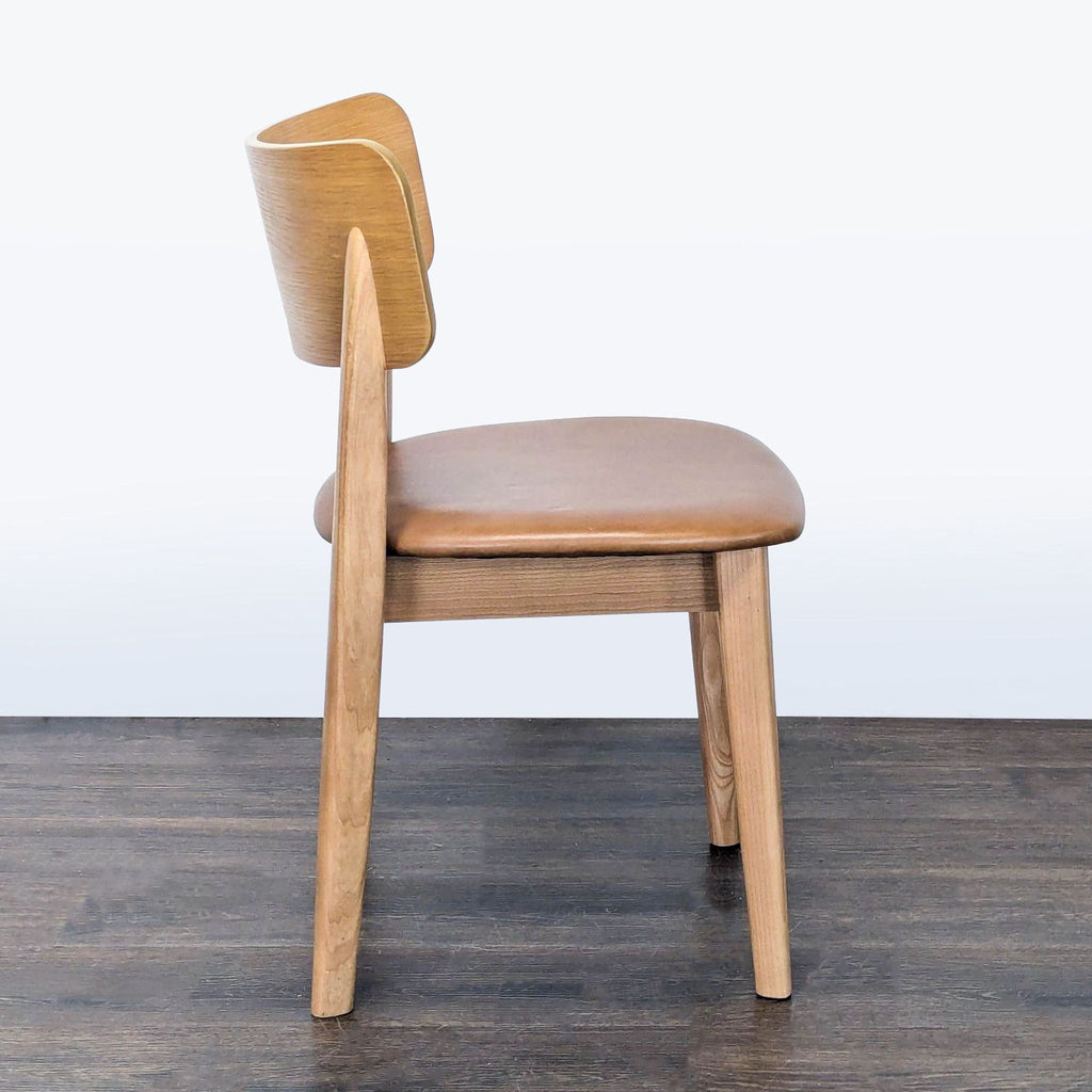 Contemporary West Elm dining chair; top grain leather cushion, sturdy ash wood, and veneered acacia accents.