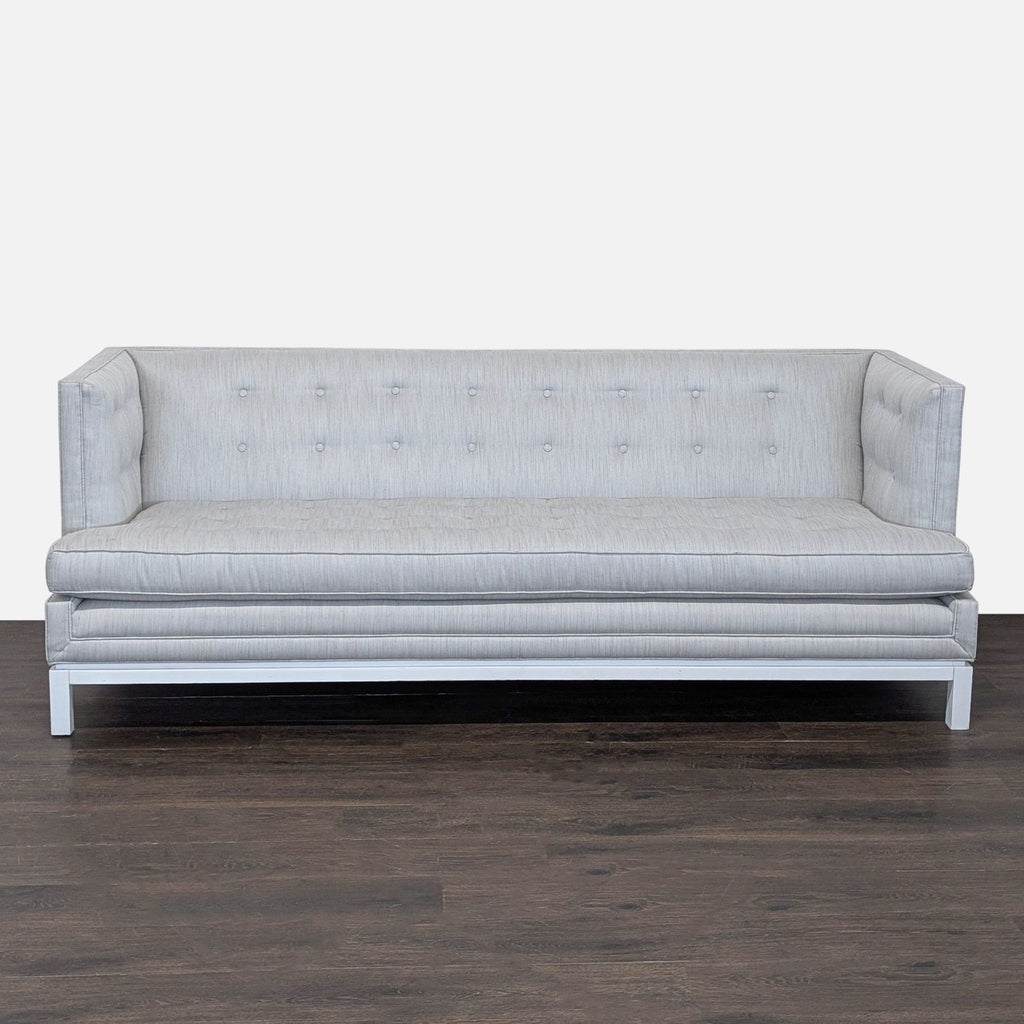 Modern 3-seat Jonathan Adler sofa with light grey upholstery, button tufting, and a raised white base.