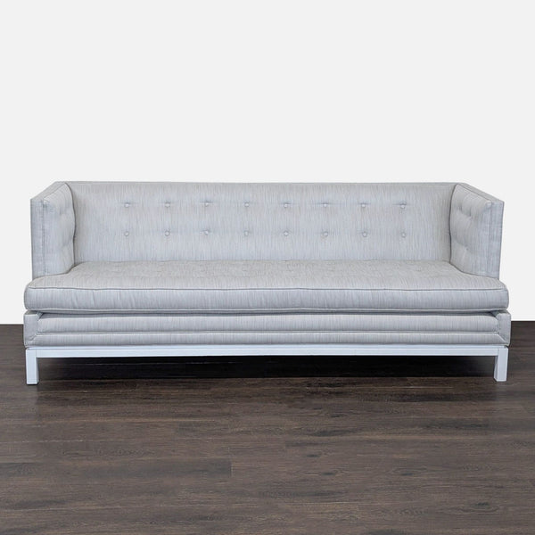 Modern 3-seat Jonathan Adler sofa with light grey upholstery, button tufting, and a raised white base.