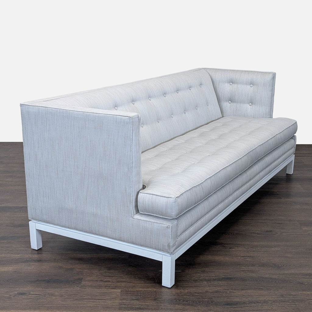 Contemporary light grey Jonathan Adler 3-seater featuring button-tufted backrest and sleek white leg base.