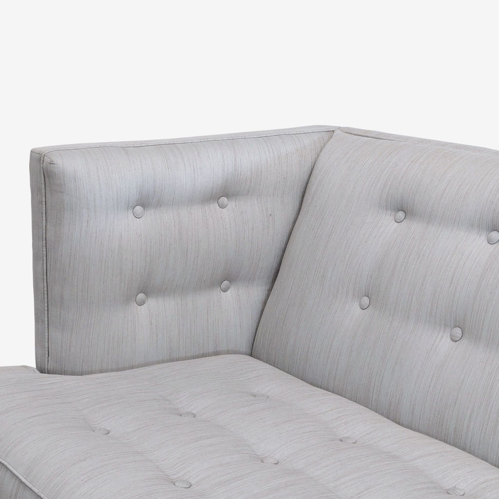 Stylish Jonathan Adler three-seat sofa with structured lines, grey fabric, tufted design, and white foundation.