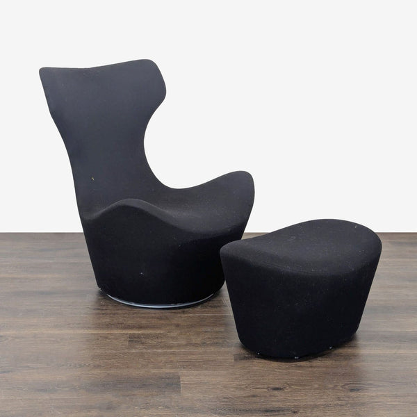 Modern B&B Italia black lounge chair with contoured back and matching ottoman for sophisticated relaxation.  