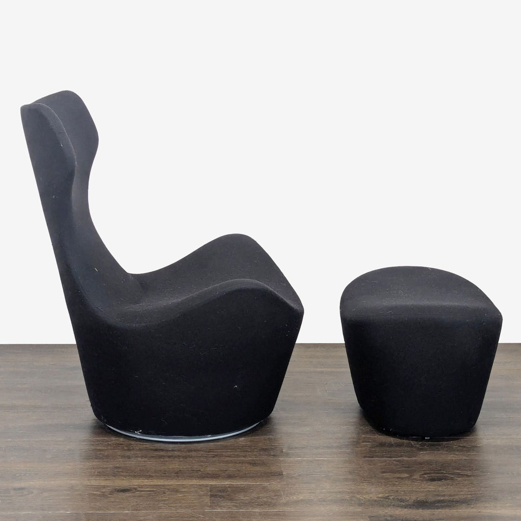 Sleek black fabric lounge chair and ottoman set by B&B Italia, offering supportive comfort and stylish design.  