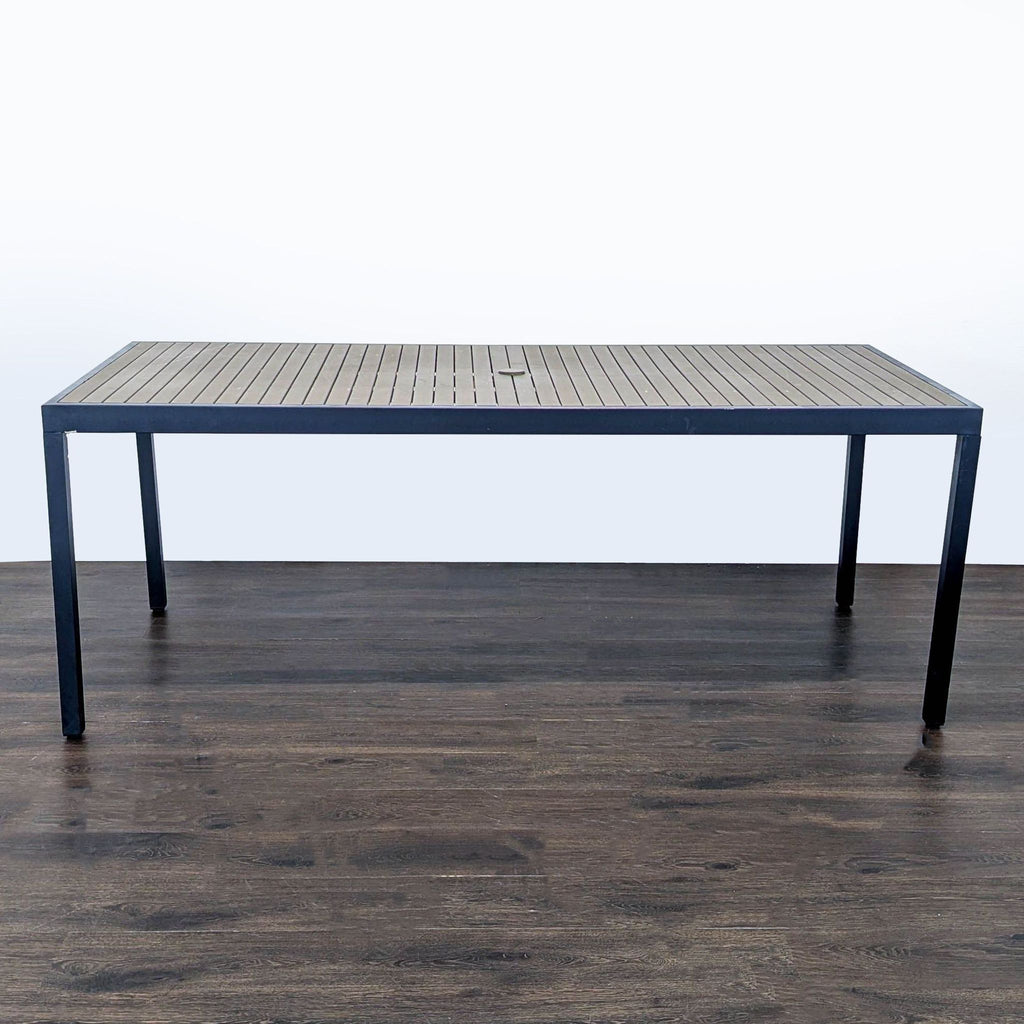 Modern Crate & Barrel table with slatted top and metal frame, suitable for dining indoors or outdoors.  