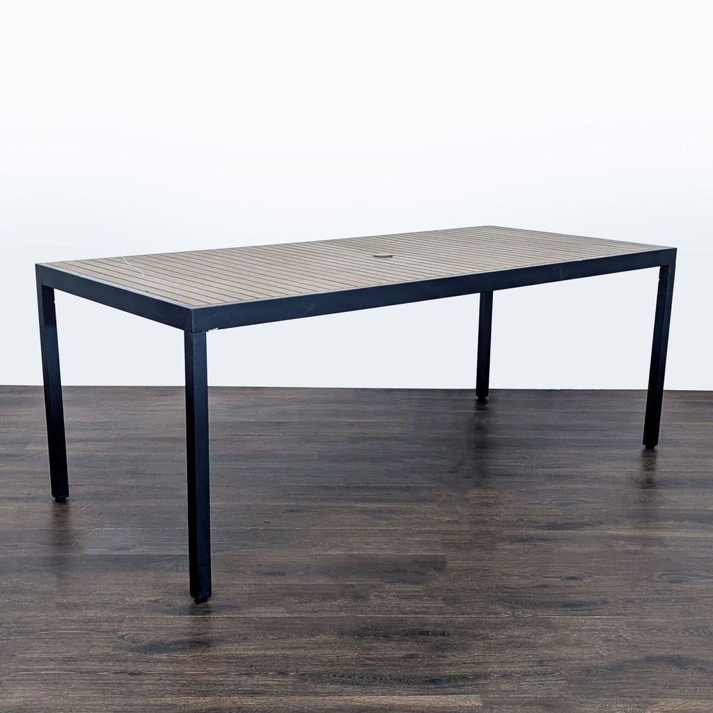 Contemporary dining table by Crate & Barrel featuring a spacious, slatted surface and neutral palette.  