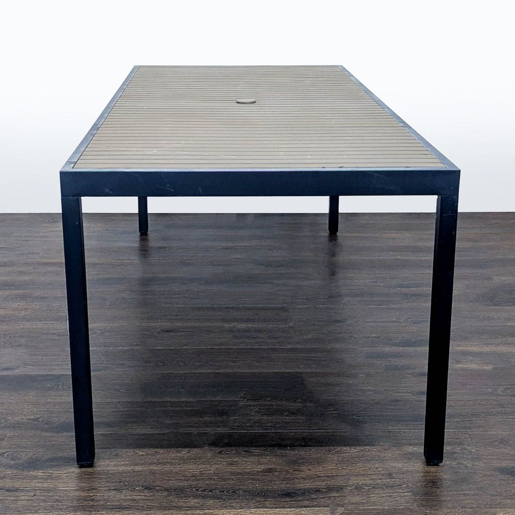Sleek Crate & Barrel table with sturdy metal base and clean lines, ideal for versatile use in any space.