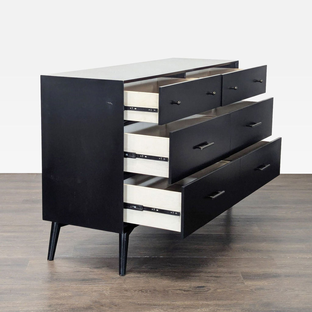 Modern Living Spaces dresser with six roomy drawers, metal hardware, and a minimalist black finish.