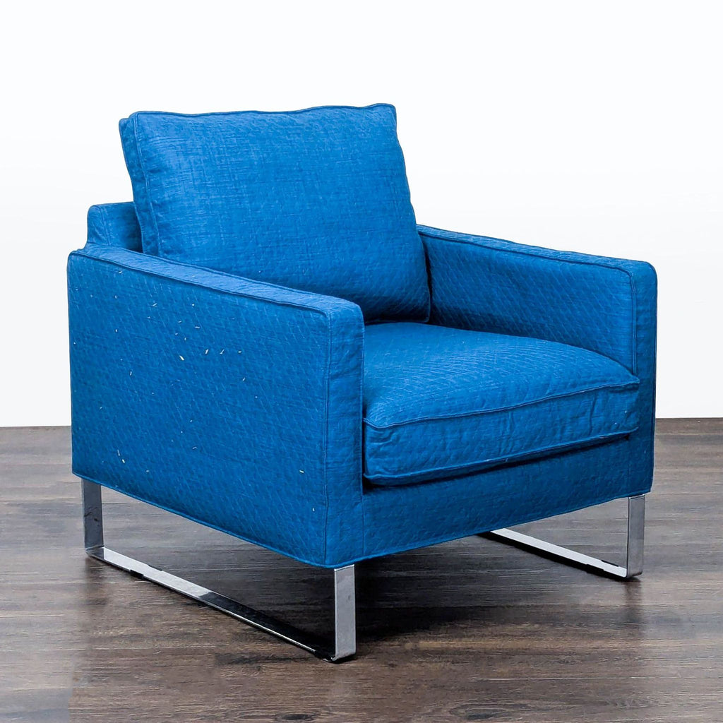 Stylish Ikea armchair in bold blue fabric, featuring metal legs and minor wear, ideal for living rooms.  