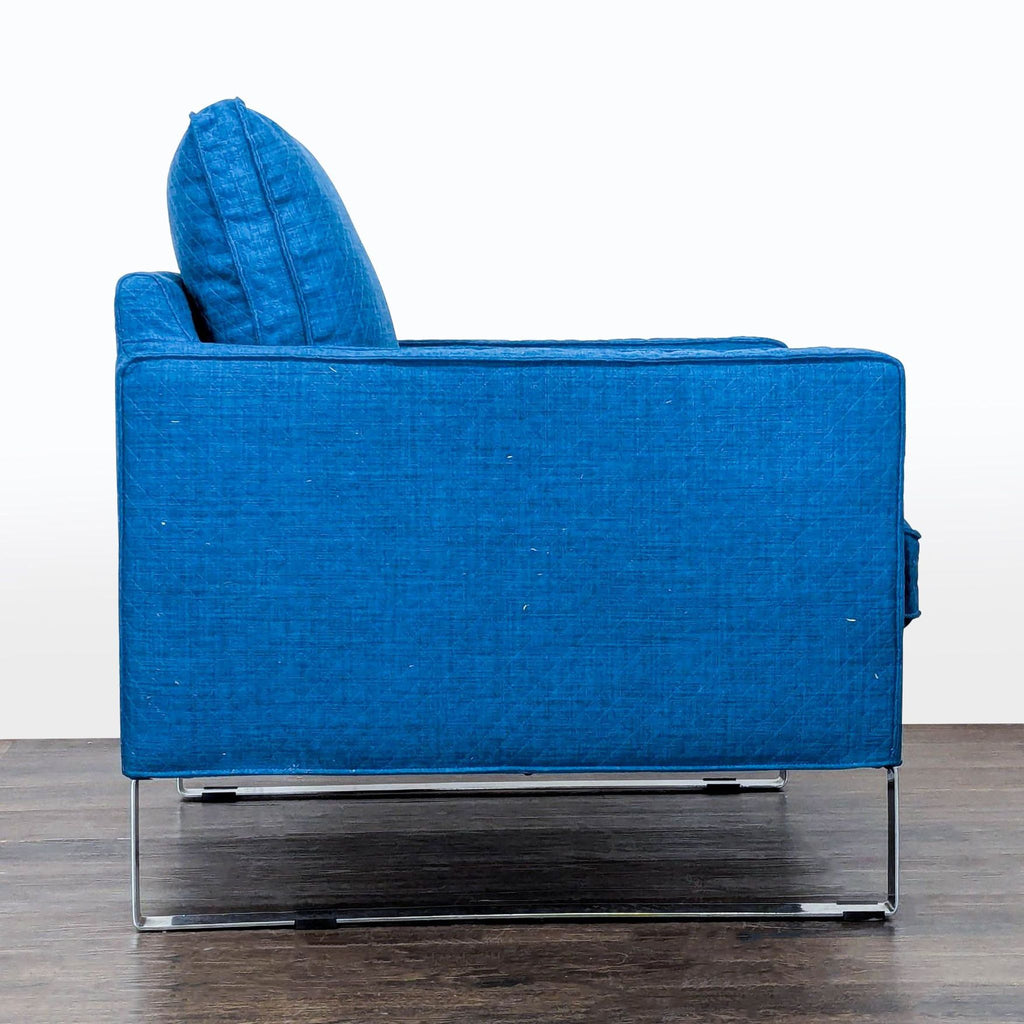 Comfortable blue Ikea lounge chair with sleek metal legs, supportive cushioned back and minor arm scuffs.